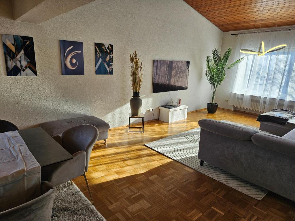 a living room with two couches and a tv at Ferienwohnung Renaissance in Backnang