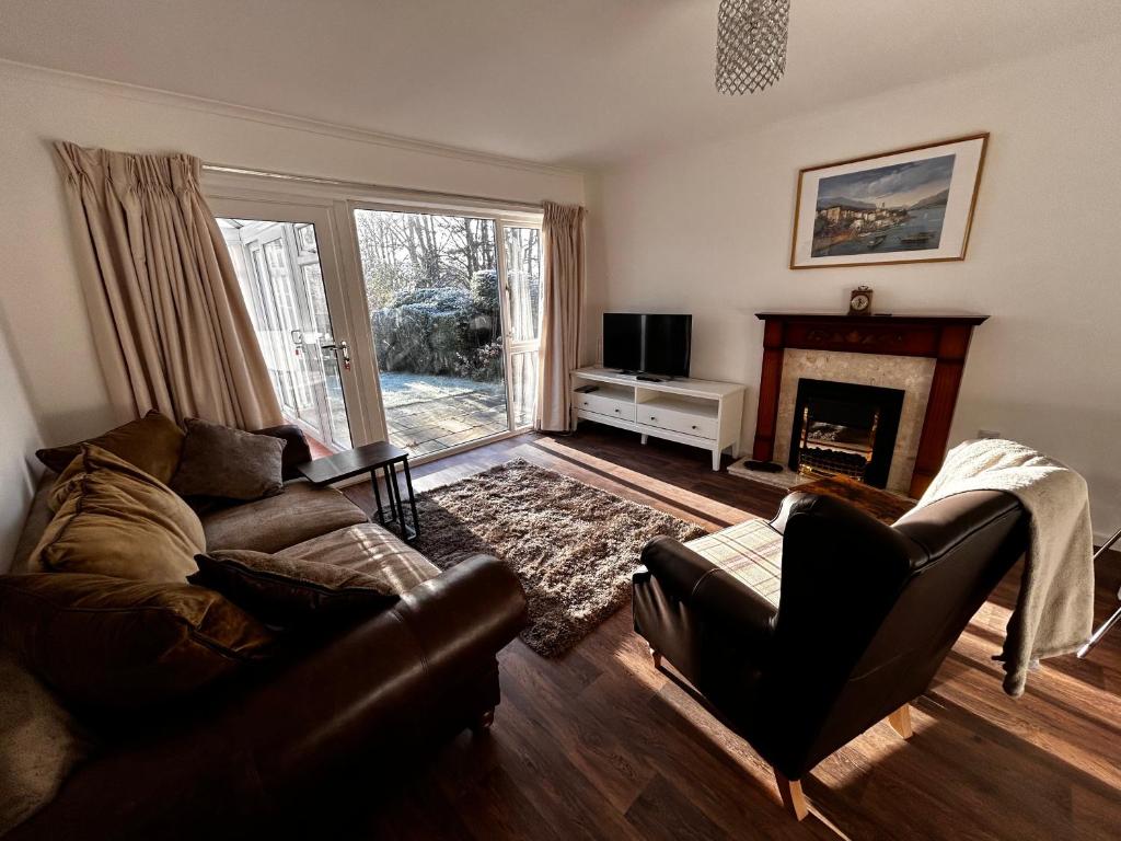 a living room with a couch and a fireplace at The Eves in Corbridge