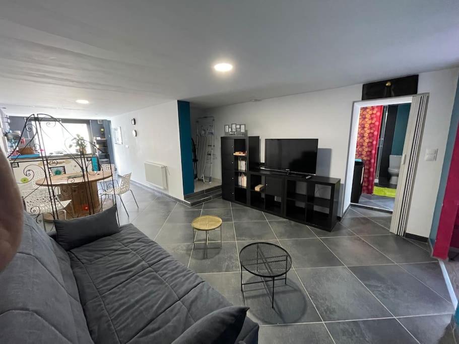 a living room with a couch and a table at Logement du Paquis in Les Mazures