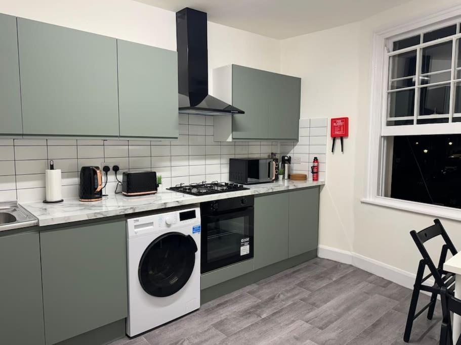 a kitchen with a washing machine and a stove at Room 3 • Double Bed in London King’s Cross in London