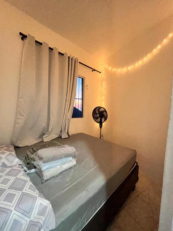 a bedroom with a bed and a window with lights at Não façam a reserva , não está disponível , o app não tá deixando tirar mais da página in Rio de Janeiro