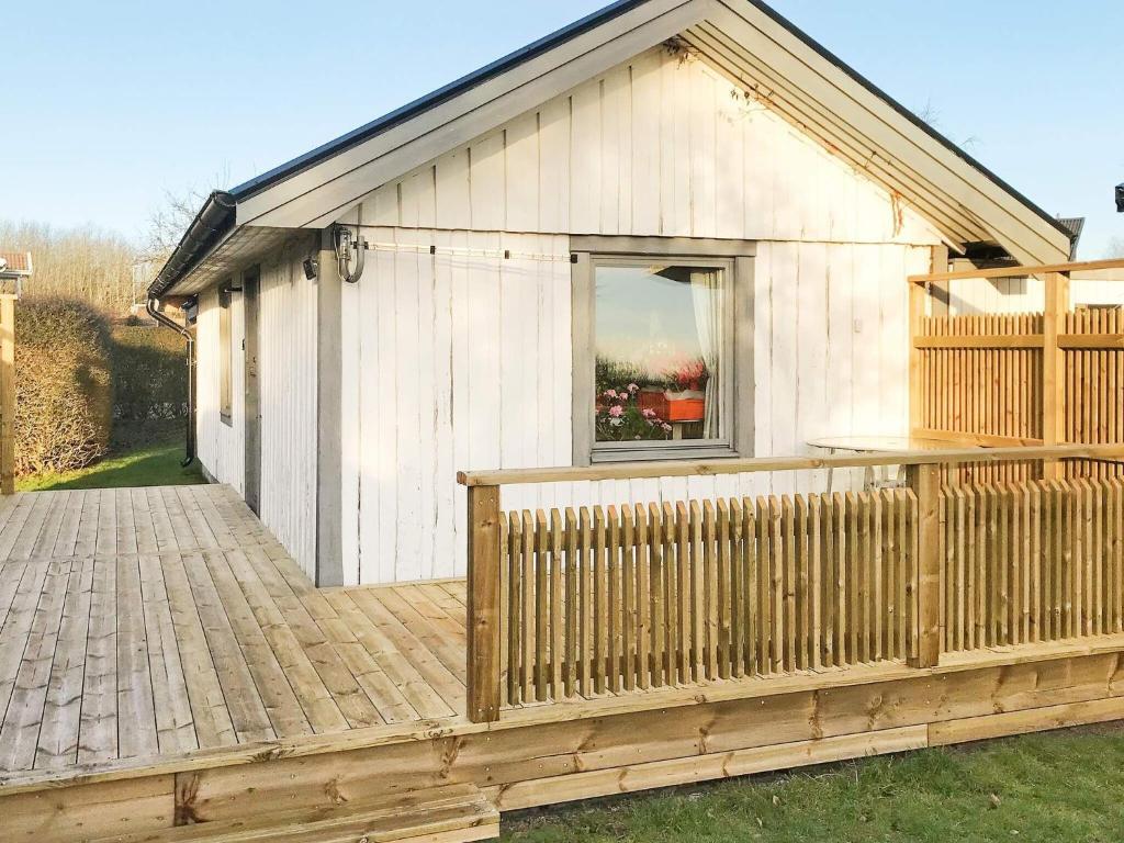 a wooden house with a deck and a window at 2 person holiday home in Falkenberg in Falkenberg