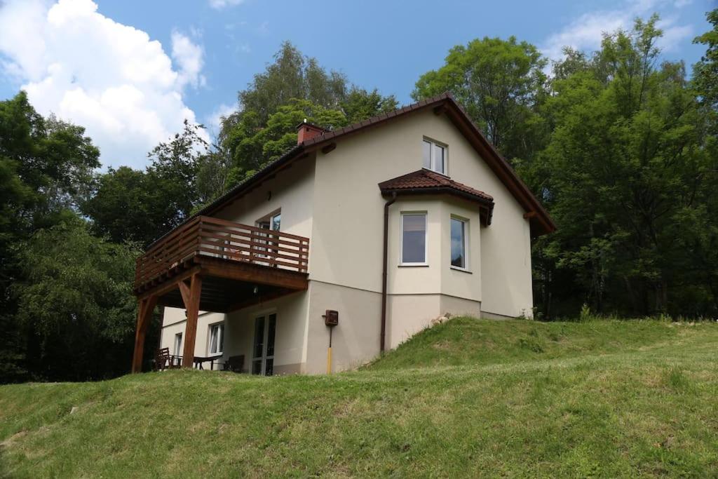 a house on top of a grassy hill at Porąbka - nocleg w urokliwym miejscu in Porąbka