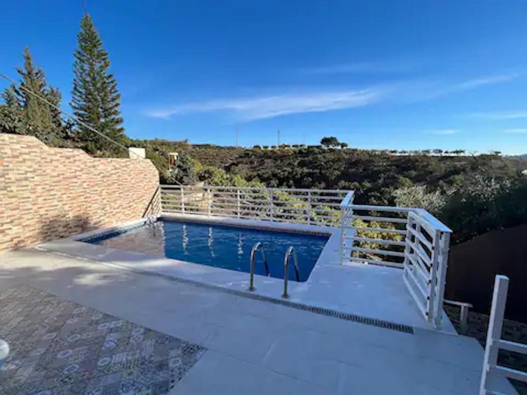 a swimming pool with a fence around it at Villa del Sol in Málaga