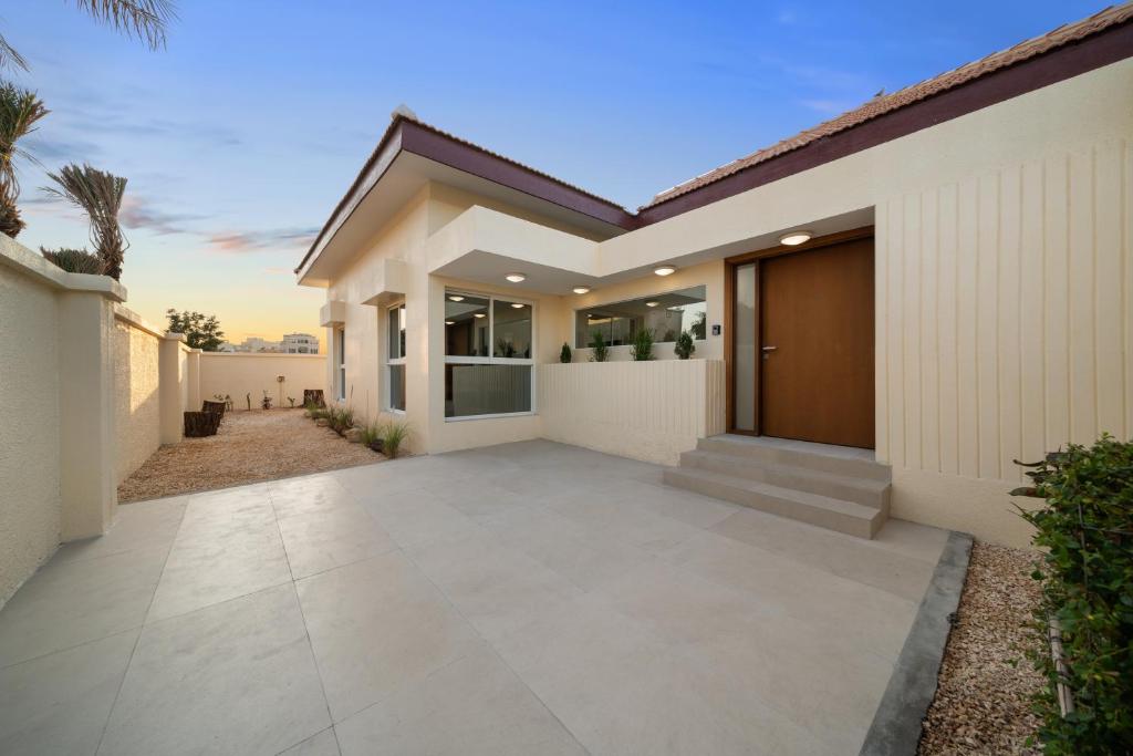 a villa with a driveway leading to a house at Jumeirah Three Bedroom House in Dubai