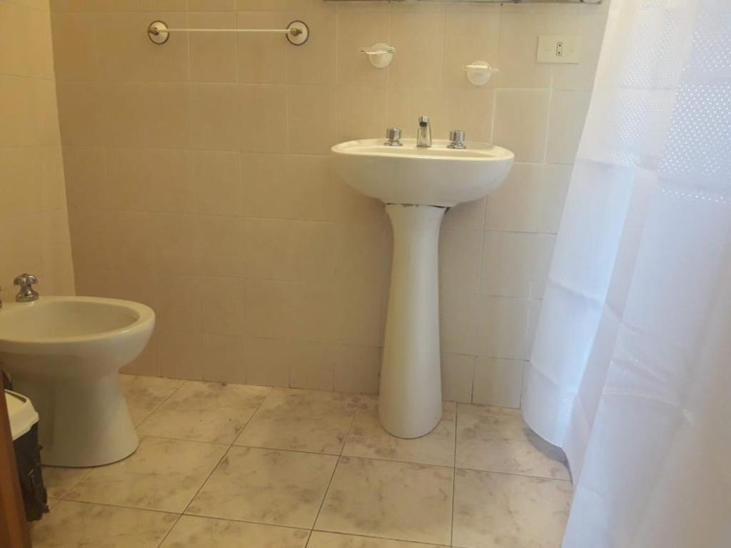 a bathroom with a sink and a toilet at Ruka Leufu in Santa Rosa de Calamuchita