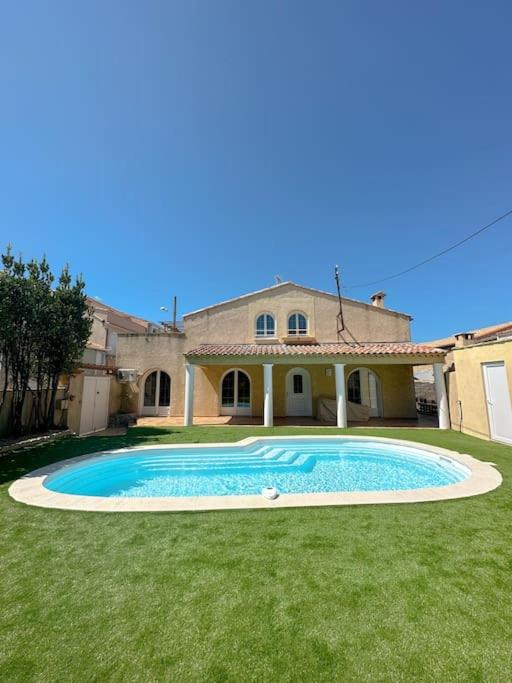 une grande piscine devant une maison dans l'établissement La nature mezoise, à Mèze