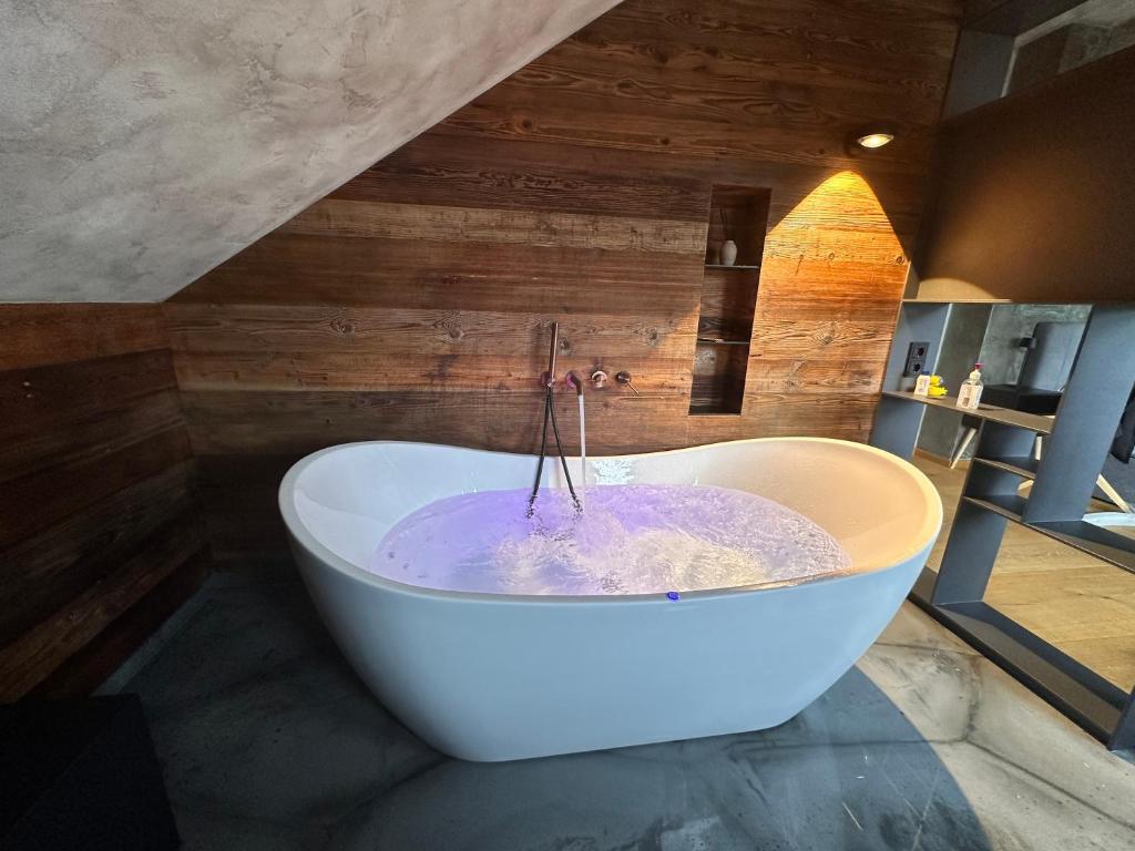 a bath tub in a bathroom with purple liquid at Appartement der Extraklasse mit Whirlpool in Roding