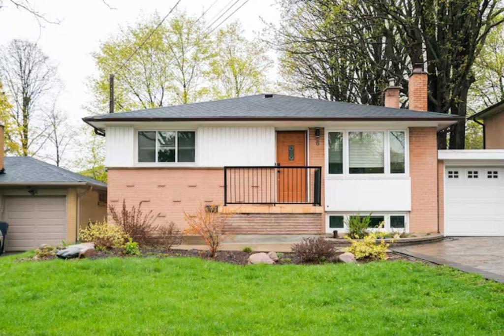 a small house with a porch and a door at Charming 2-BDR Apt, Private Entrance, Self Check-in in Toronto