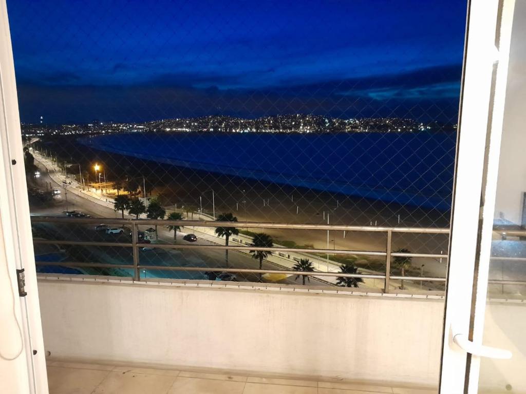a view of the ocean from a balcony at night at Hermosa Vista al Mar in Coquimbo