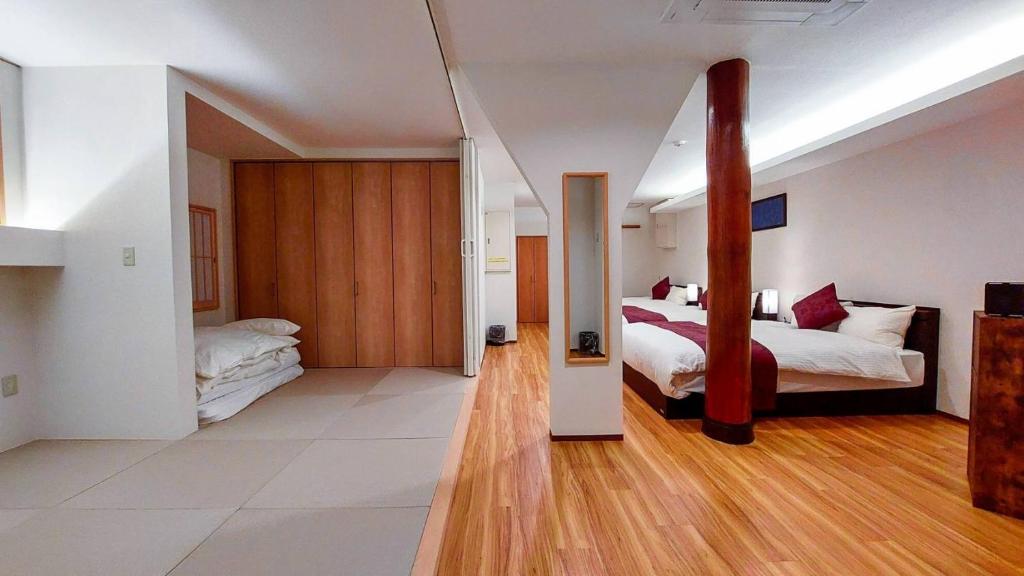 a large room with two beds and a hallway at DAVID NO YAKATA - Vacation STAY 16849v in Yufuin