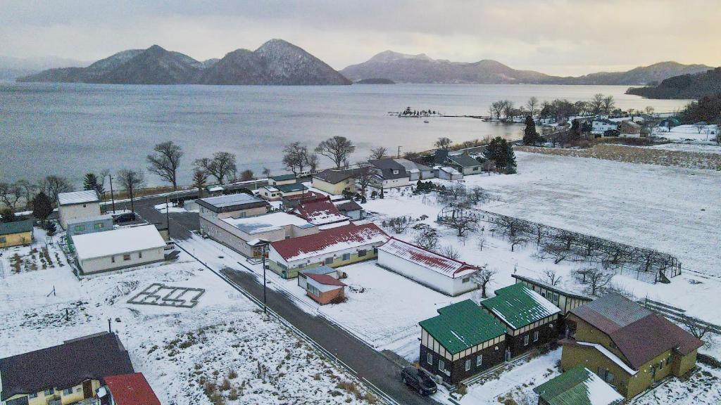 an aerial view of a town with snow covered buildings at LAKE TOYA Logde SIGRA in Lake Toya