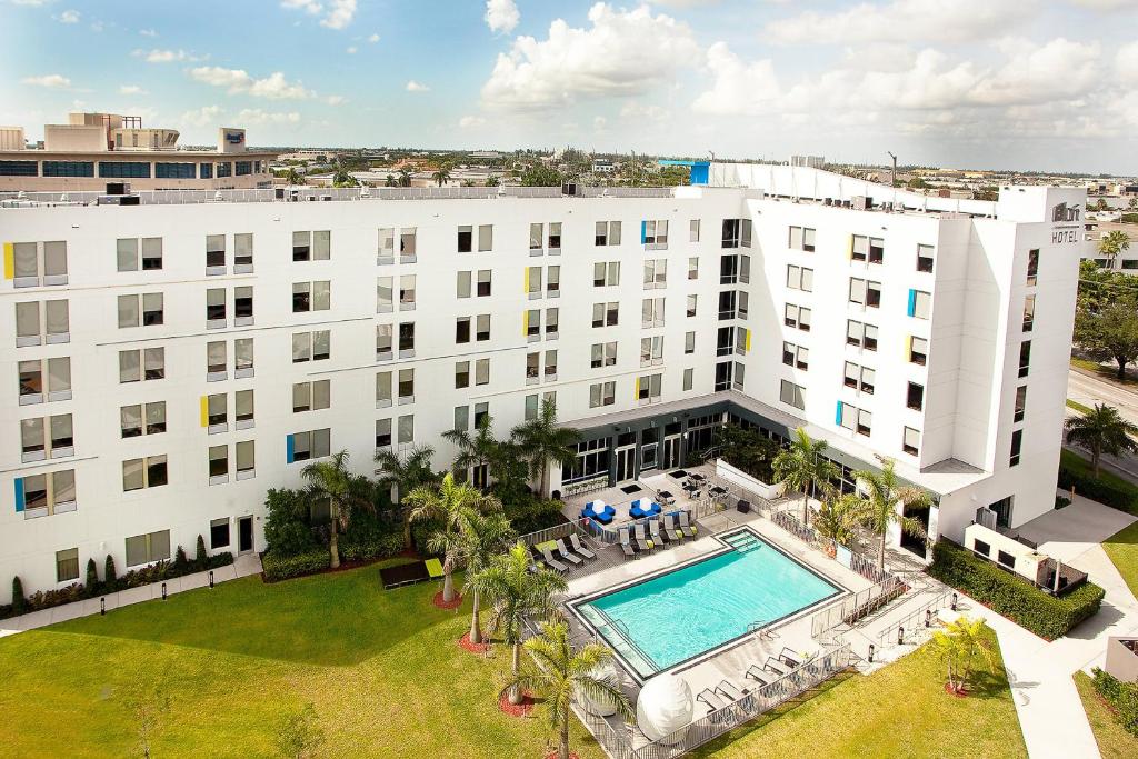 an aerial view of a building with a swimming pool at Aloft Miami Doral in Miami