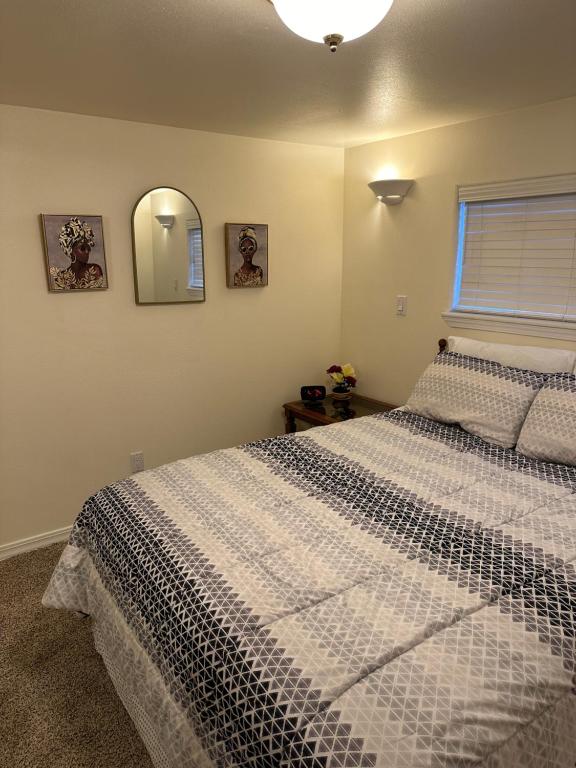 a bedroom with a white bed and a mirror at Cozy Cottage House A with Carport in Twin Falls