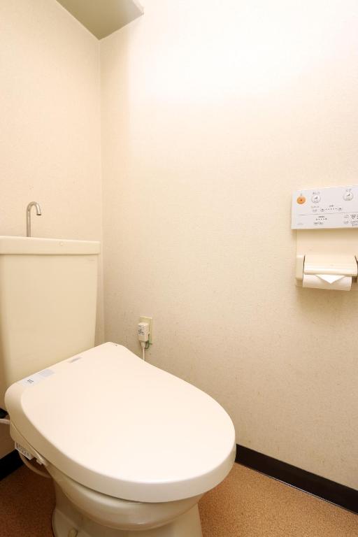 a bathroom with a white toilet in a room at Teiensaryo Yamanakako in Yamanakako