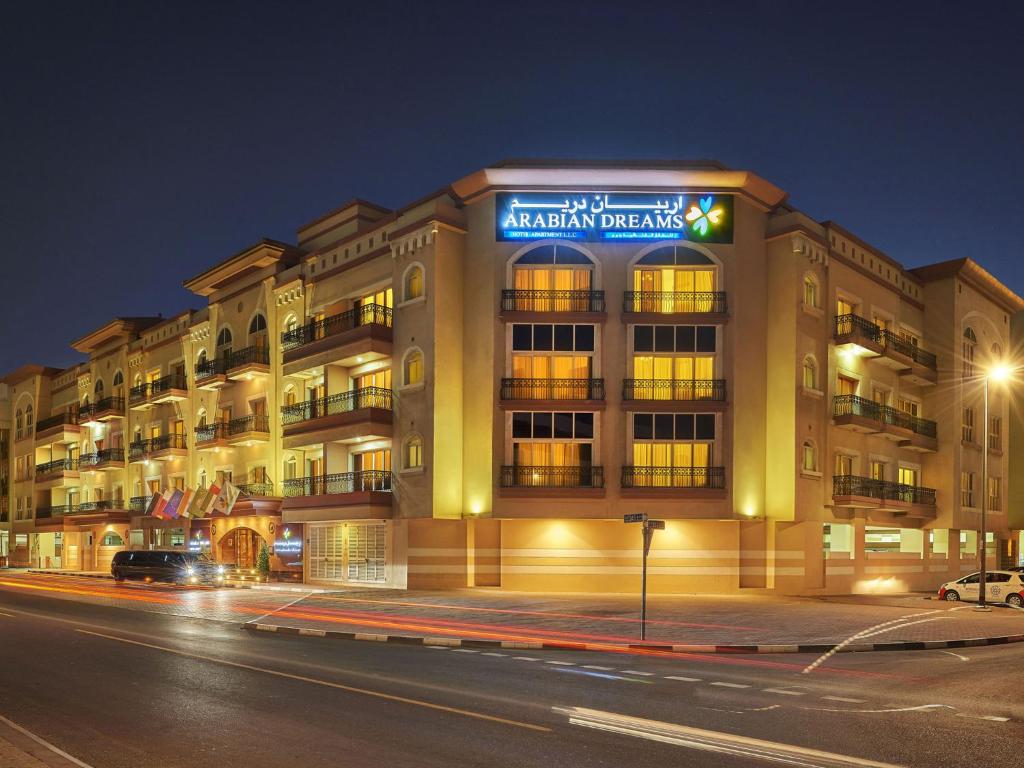 a building on a city street at night at Arabian Dreams Hotel Apartments in Dubai