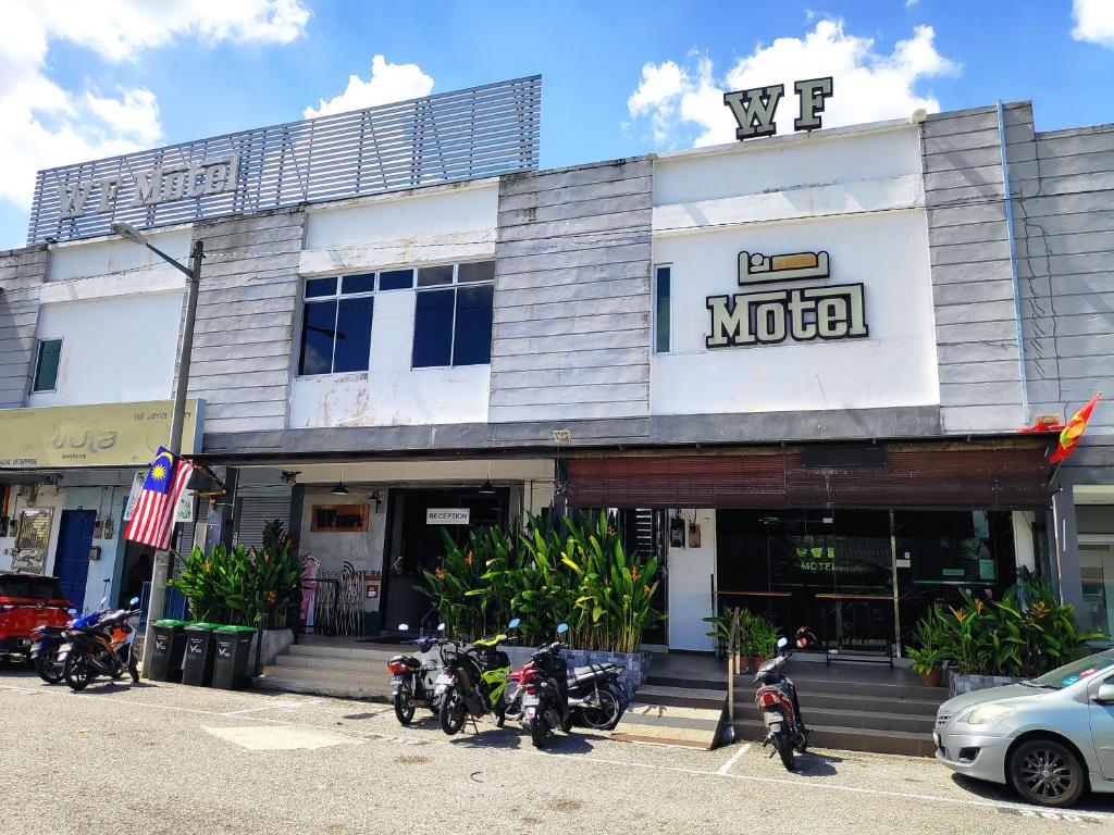 a motel with motorcycles parked in front of it at WF Motel in Kulim