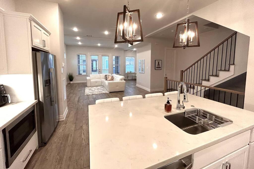 a kitchen with a sink and a living room at Townhouse in Houston in Houston