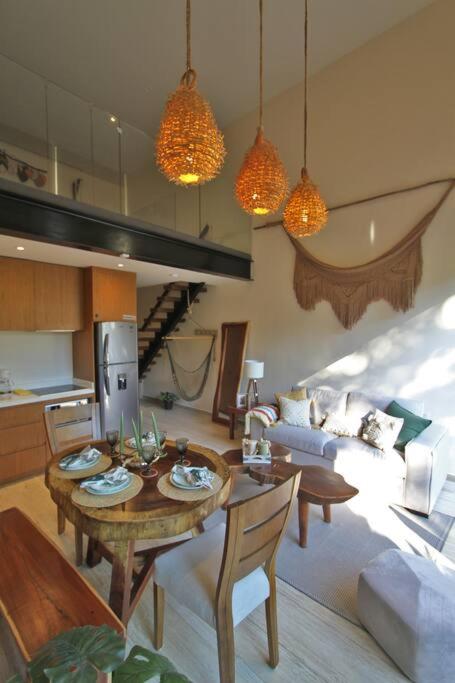 a living room with a table and a couch at Luxury Jungle Loft, 7 Pools, Rooftop Panoramic View, Beach Shuttle, Fast WiFi in Tulum