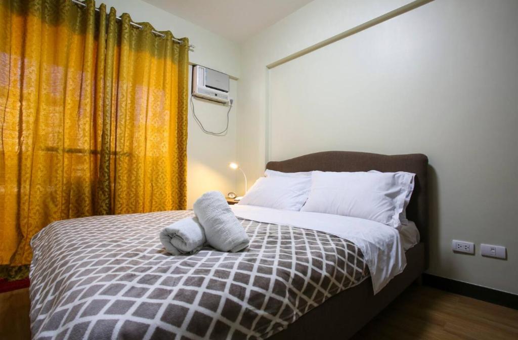 Un dormitorio con una cama con dos toallas encima. en Asteria Residences Annabel CozyPlace highspeed wifi, en Manila