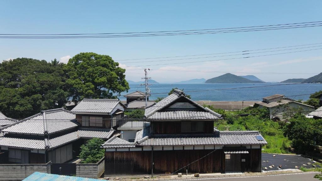 a group of buildings with mountains in the background at Private Chill Base たまて 