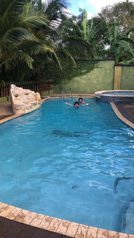 a person swimming in a swimming pool in a swimming pool at Hidden oasis in Mandeville