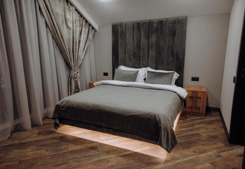 a bedroom with a large bed with a large headboard at Moonlight in Tsaghkadzor
