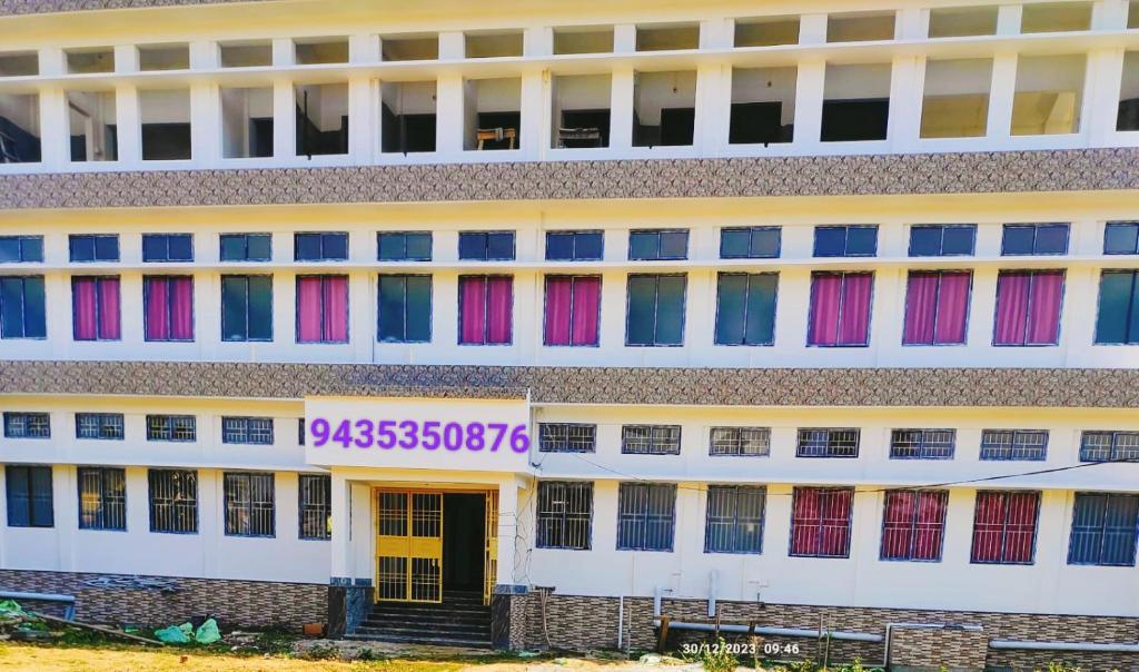 a building with colored windows and a sign on it at TAJ HERITAGE Hotel And Restaurant -call 94353-5O876 in Jorhāt