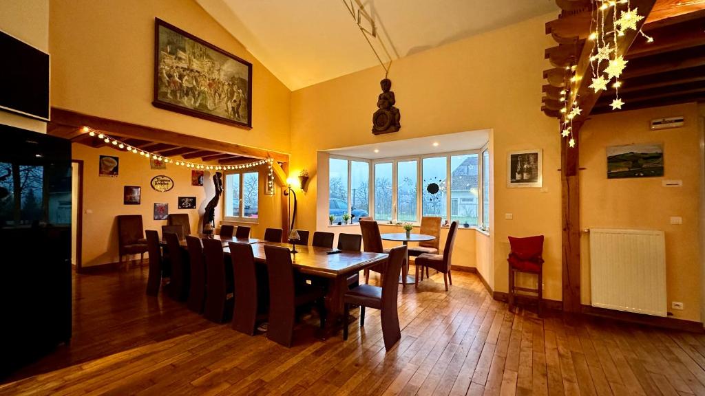 a dining room with a table and chairs at Gîte rural Le Péché Mignon in Lignol-le-Château