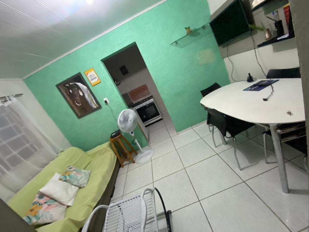 a room with a table and a couch and a table at Flat imobiliado feitosa in Maceió