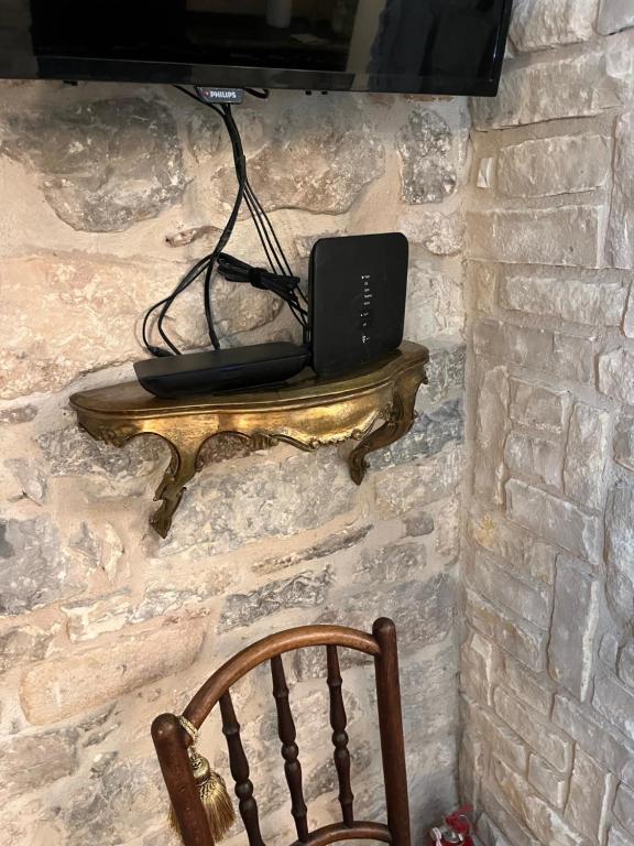 a laptop sitting on a shelf on a stone wall at Apartment Venus of the Palace - NEW RENOVATED in Split