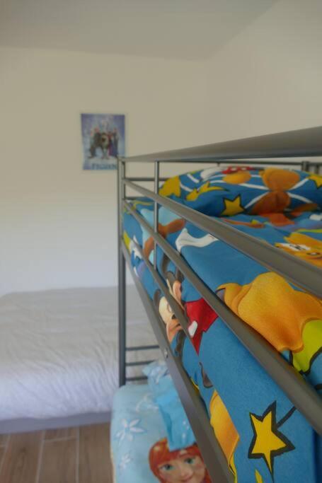 a bunk bed with two bunk beds in a room at Disneyland Paris, appartement 70m², parking privé in Serris