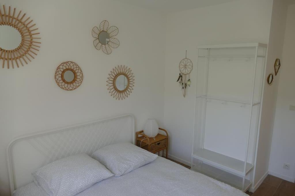 a bedroom with a bed and mirrors on the wall at Disneyland Paris, appartement 70m², parking privé in Serris
