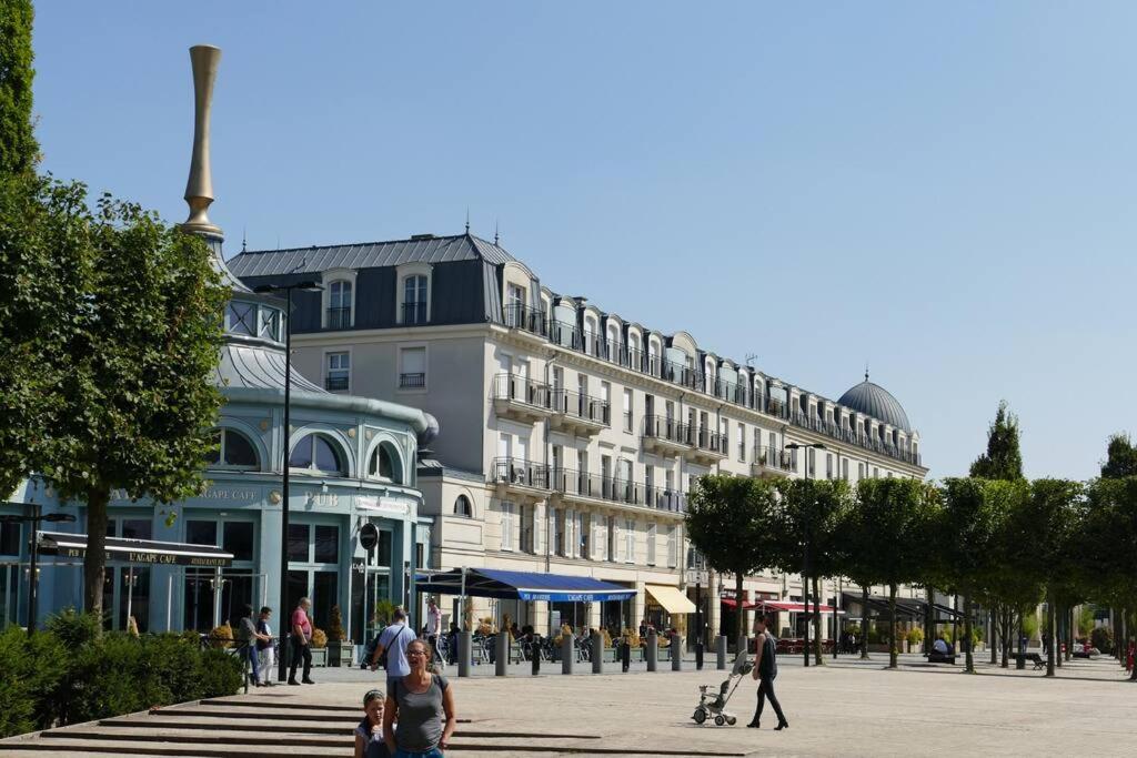 a large building with people walking in front of it at Disneyland Paris, appartement 70m², parking privé in Serris