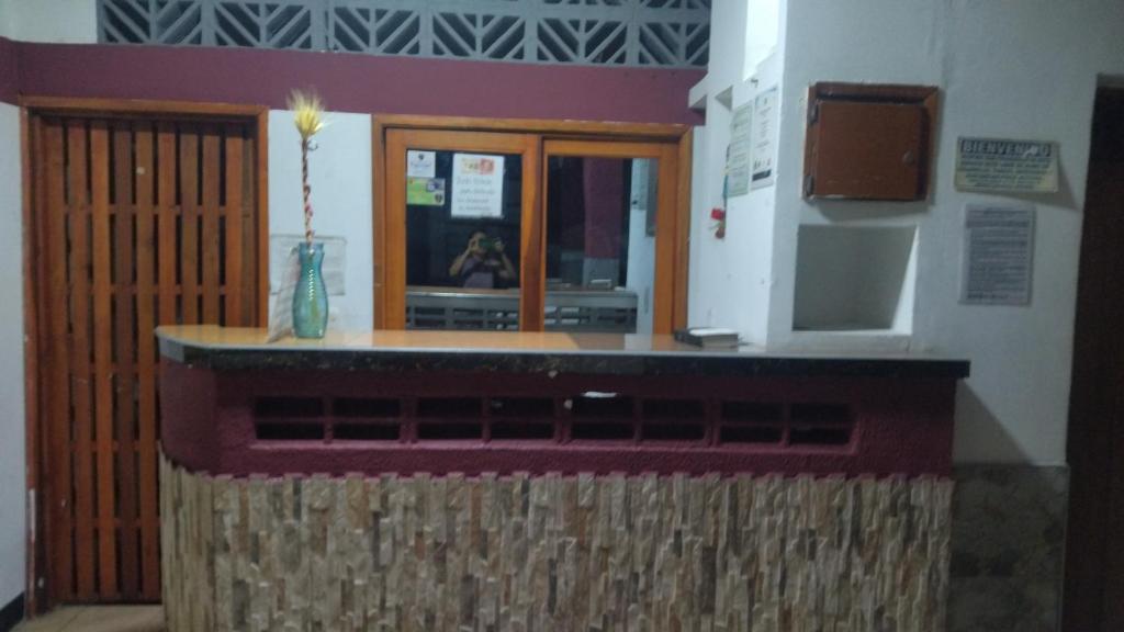 a kiosk in a building with a counter and a window at Hotel los Mangostinos cl 7#5-26 in Mariquita