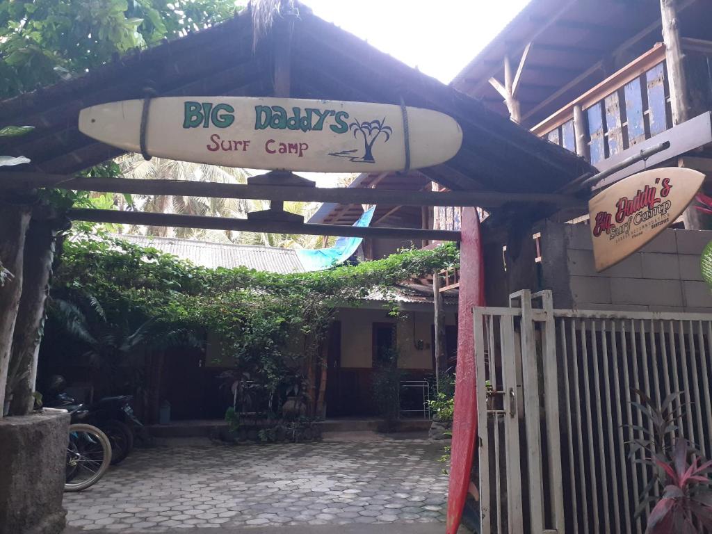 a building with a surfboard on top of it at Big Daddy´s Surfcamp in Pasanggaran