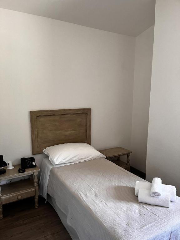 Łóżko lub łóżka w pokoju w obiekcie HOTEL CAMPO STELLA