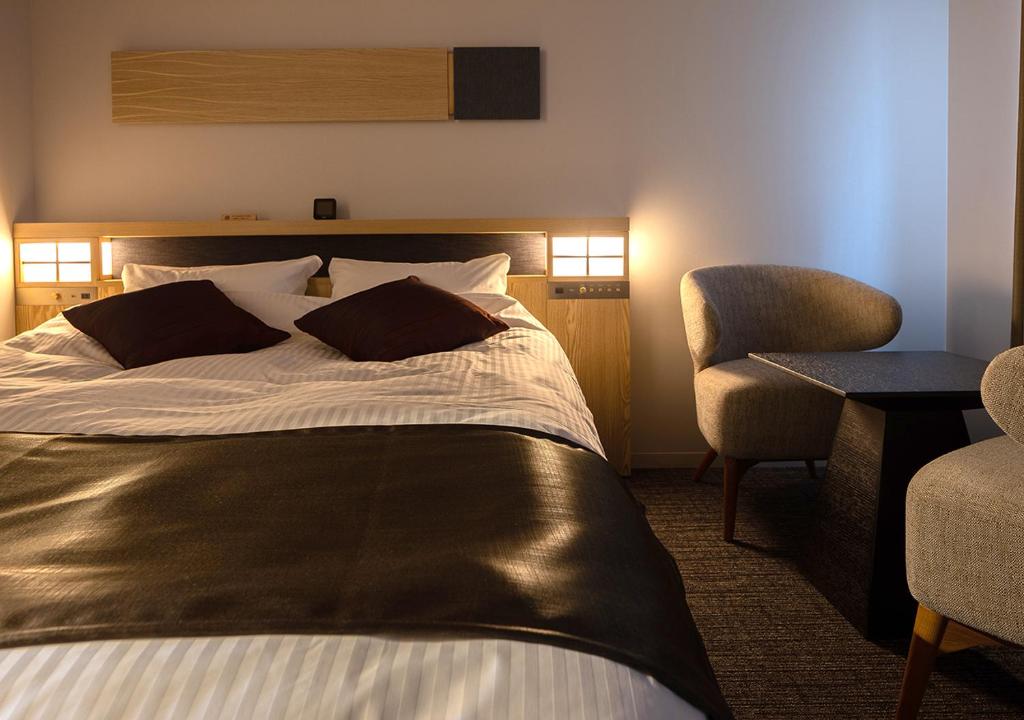 Postel nebo postele na pokoji v ubytování Hotel Grand Cocoe Kurashiki