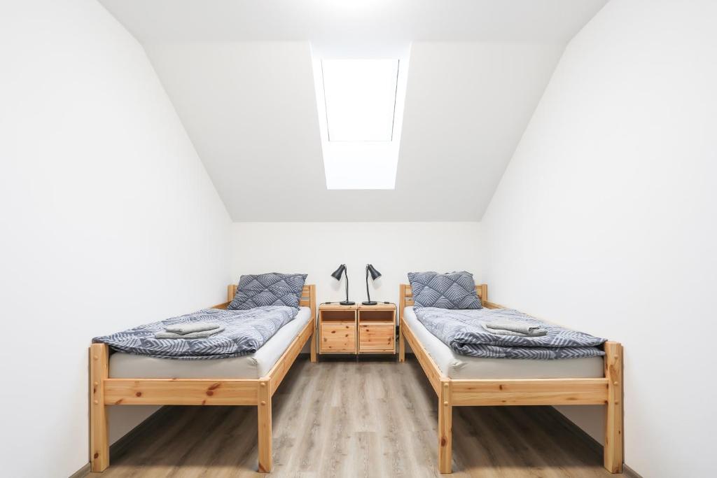 duas camas sentadas uma ao lado da outra num quarto em Ubytování Osové em Velké Mezirici
