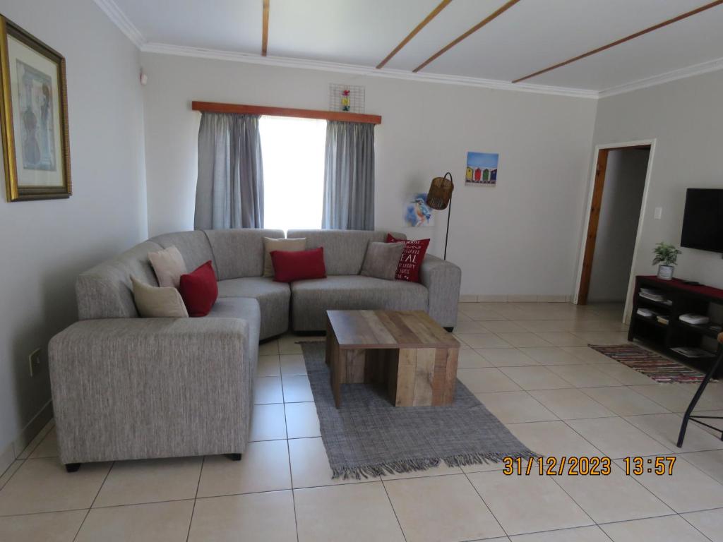 a living room with a couch and a coffee table at Be My Guest in Swakopmund