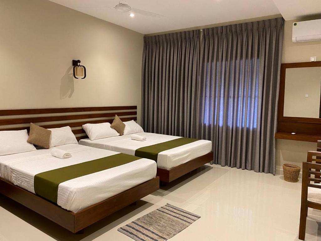 Postel nebo postele na pokoji v ubytování Lamandu City Hotel