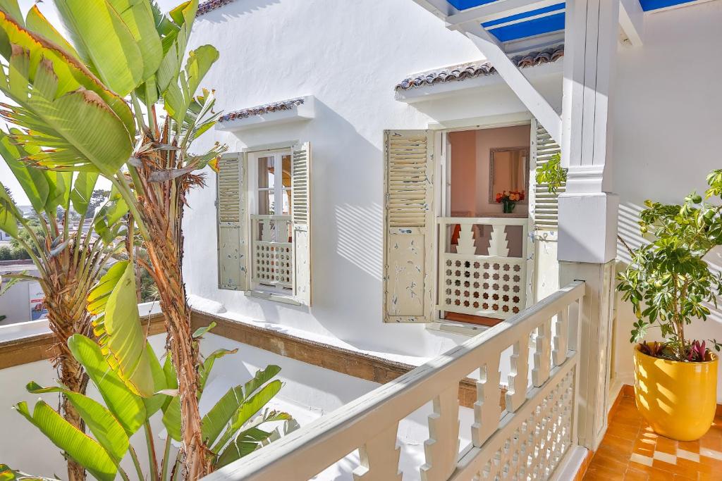 a white house with white stairs and windows at Chems Bleu in Essaouira