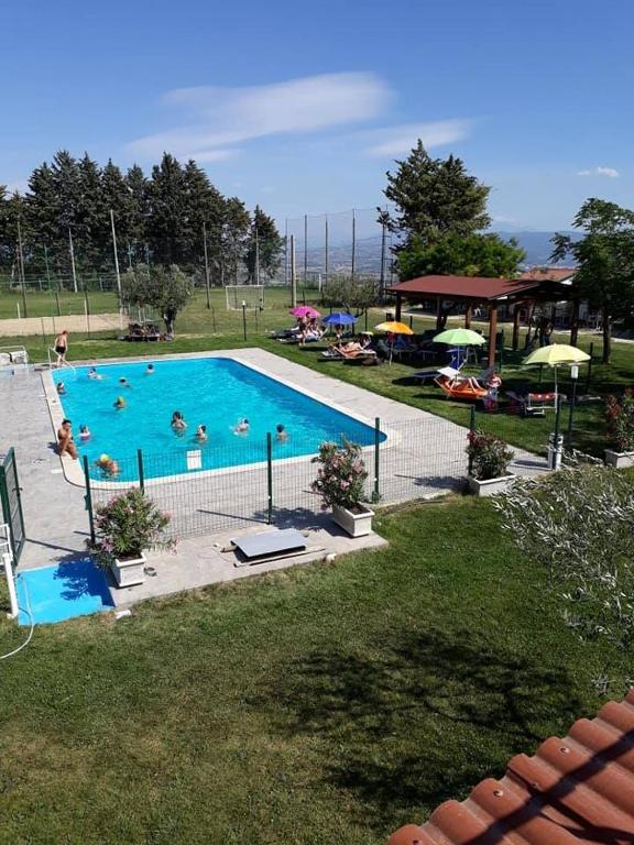a large swimming pool with people swimming in it at Agriturismo Alta Collina in Benevento