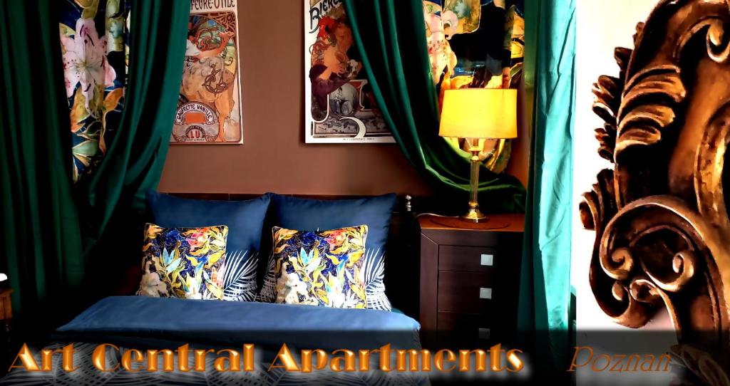 a bedroom with a bed with green drapes at Central Apartments in Poznań