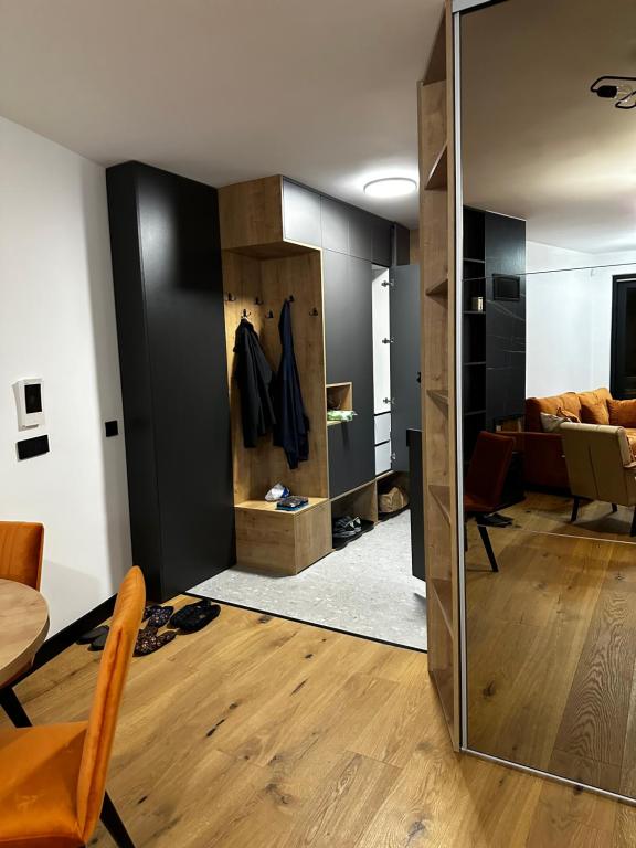 a room with a mirror and a living room at Apartment Aurora in Bjelašnica