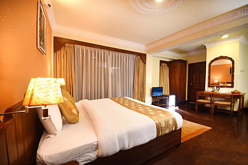 Postel nebo postele na pokoji v ubytování Nirvana Boutique Hotel