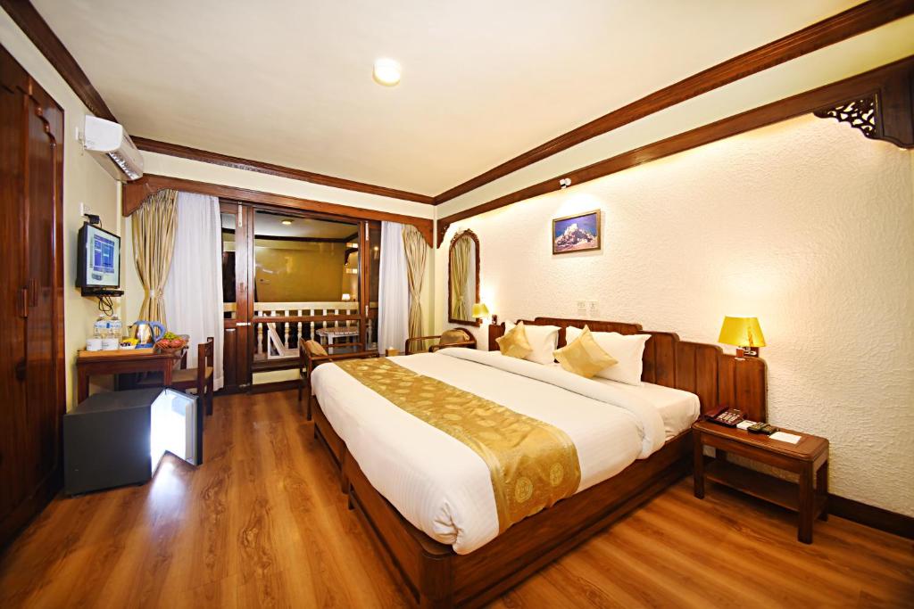 Postel nebo postele na pokoji v ubytování Nirvana Boutique Hotel