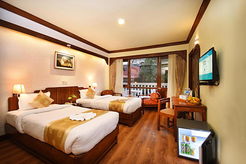 Postel nebo postele na pokoji v ubytování Nirvana Boutique Hotel