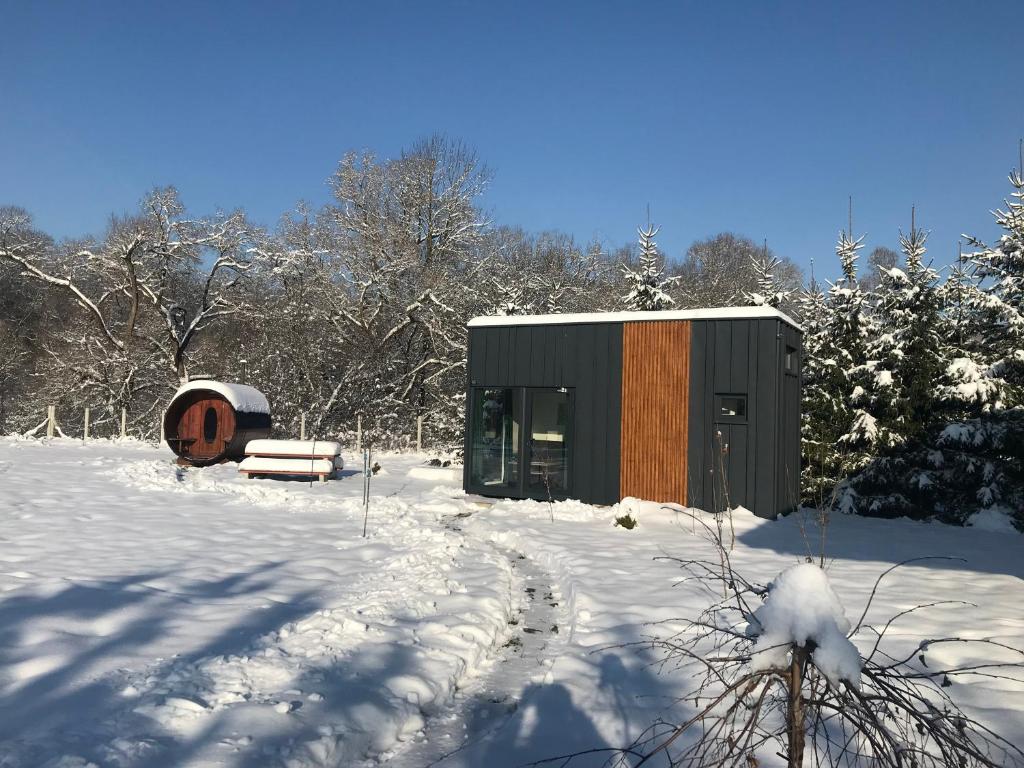 a small cabin in the snow in the woods at TinyHouses & Garden in Oravská Poruba