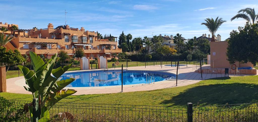 een villa met een zwembad in een tuin bij Casares del Sol penthouse with private roof terrace 80m2 in Bahia de Casares